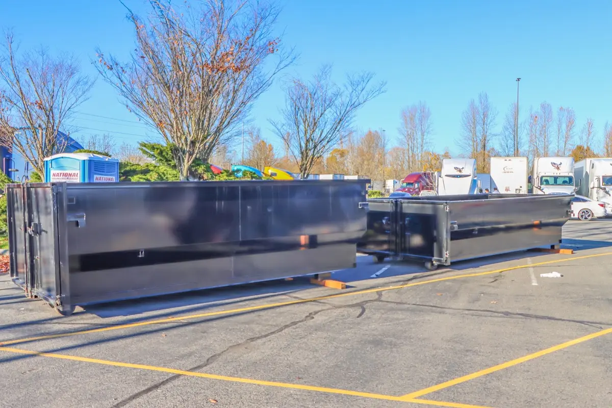 Professional dumpster rental service with roll-off container on residential driveway in New Philadelphia